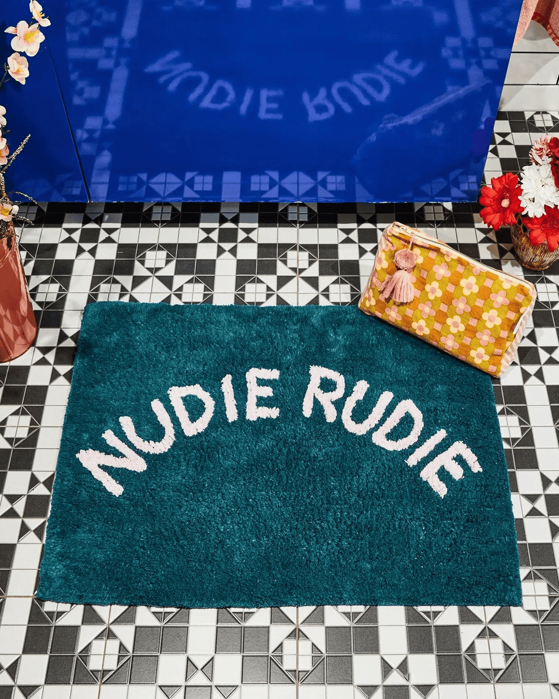tula tufted bath mat with nudie rudie writing in peacock colour